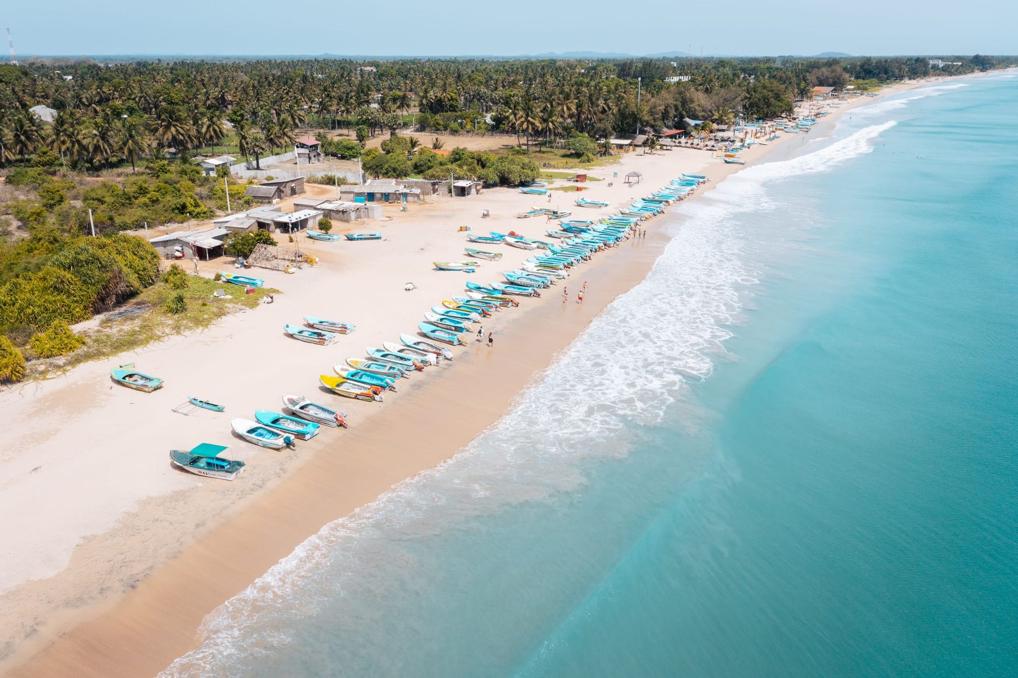 Nilaveli beach from the air: fishing boats on white sand beside turquoise sea