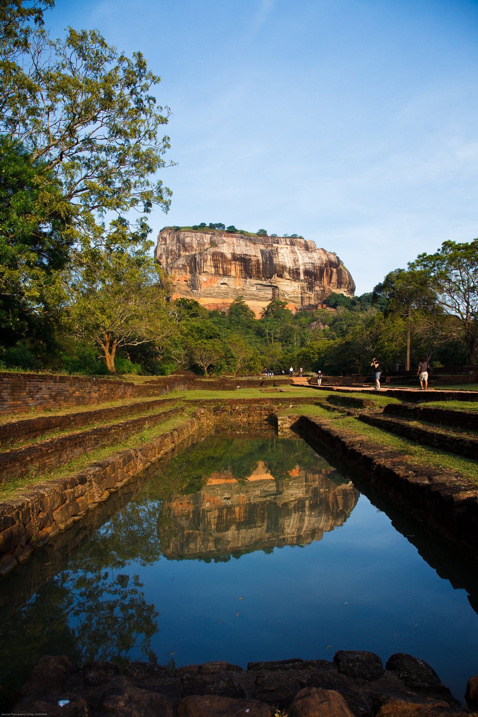Sigiriya rock and its reflection in a long pool in the palace gardens