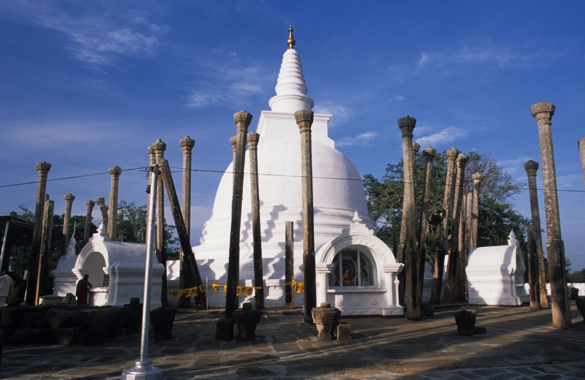 The white Thuparamaya dagoba ringed by slender stone pillars, Anuradhapura